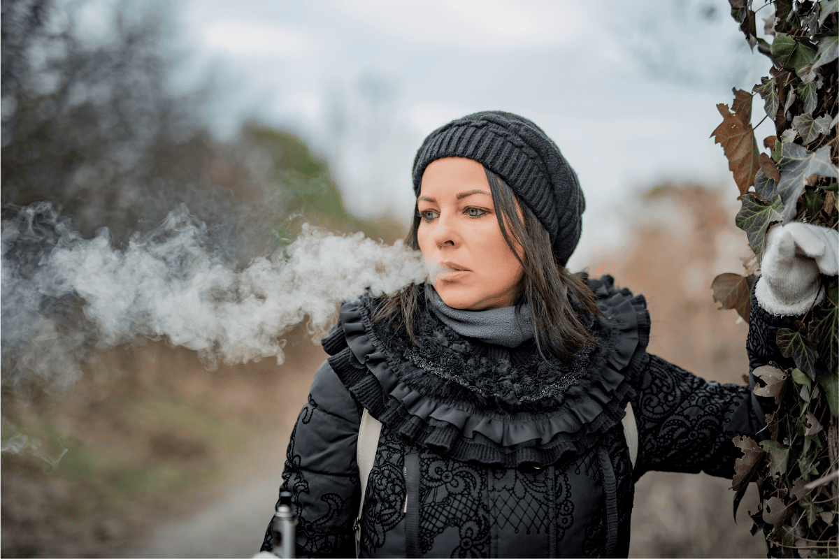Woman Outside in the Cold Vaping